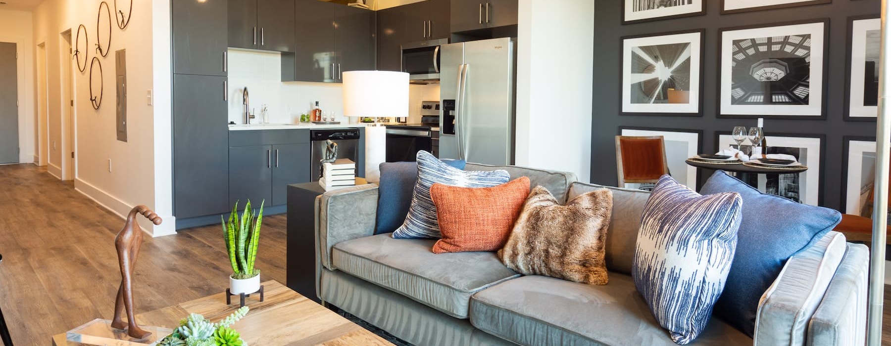 Living room with a view of the modern kitchen at Generation ATL apartment in Atlanta